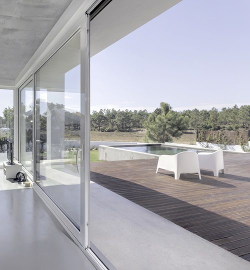 Modern house with garden swimming pool and wooden deck