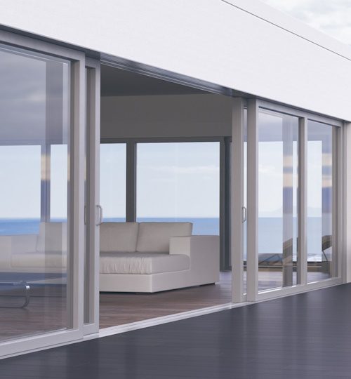 Minimalist modern villa exterior with infinity pool and beautiful ocean view.